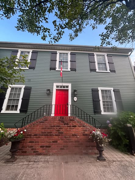 Heritage-style home in deep green with classic black shutters